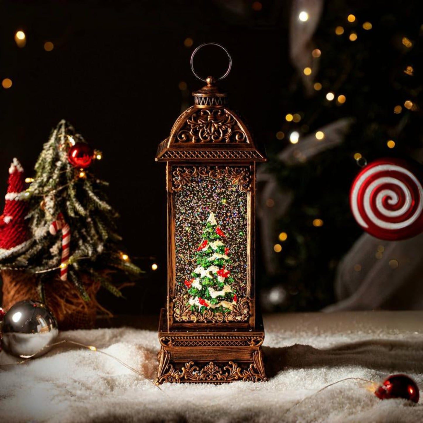 12-inch Rotating Christmas Tree snow globe lantern with red cardinals and glitter.